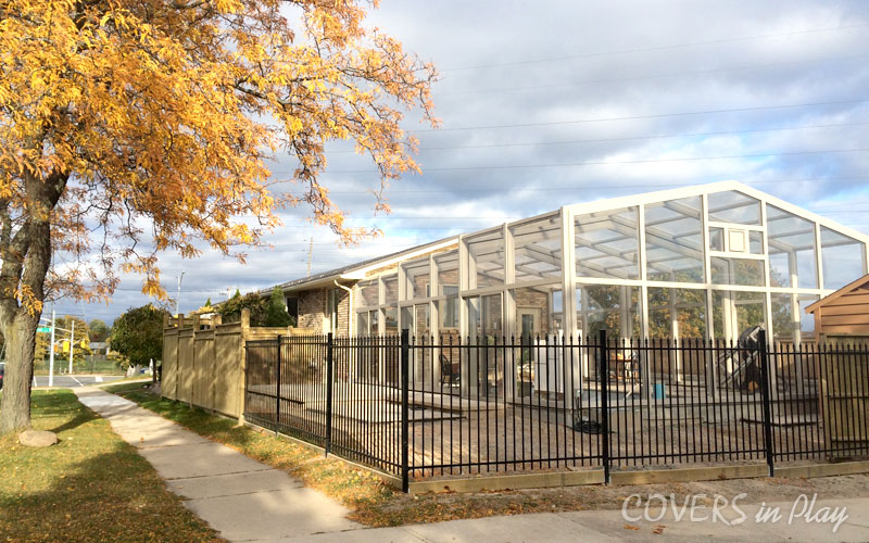 Outside view of a closed pool enclosure with clear windows in Burlington