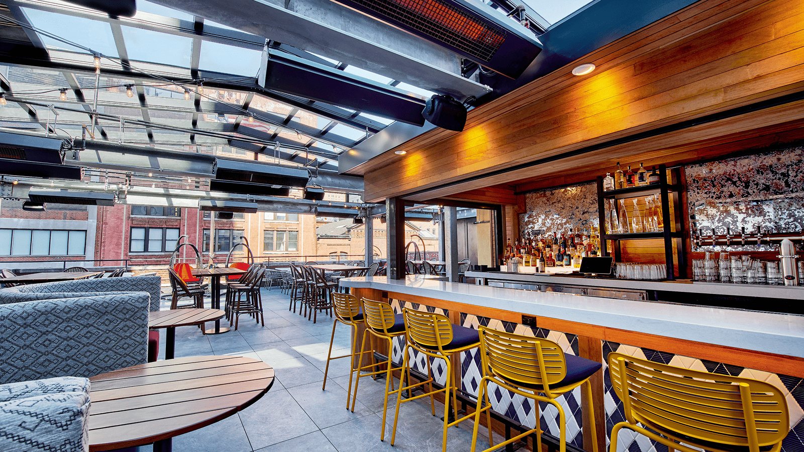 Interior of rooftop restaurant patio enclosure at Puttery in New York City, showing the open air dining area in the city.