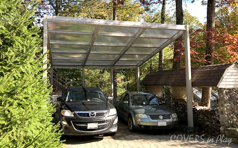 Exterior view of car port in Kinnelon, NJ, surrounded with trees, keeping the cars clear from debris