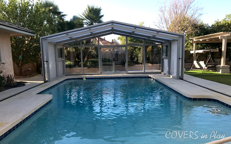  Exterior view of open pool dome cover in Mesa, AZ, in backyard with swing and trees.