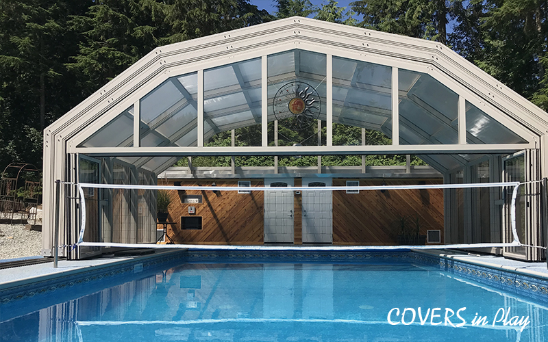 Exterior view of open pool dome surrounded by trees with volleyball net in Mission, BC, by Covers in Play