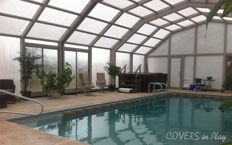 Interior view of pool dome with swim spa in Portland, ON, featuring sliding and swing doors