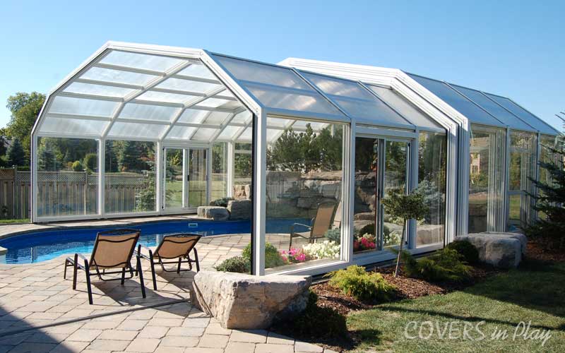 Exterior view of open pool dome in Sharon, ON, with lush landscaping and chairs