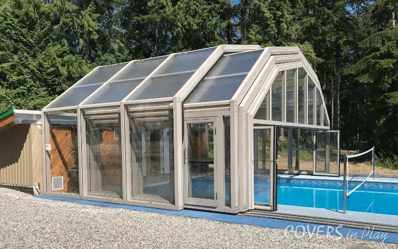 Side view of open pool enclosure with open bi-fold doors