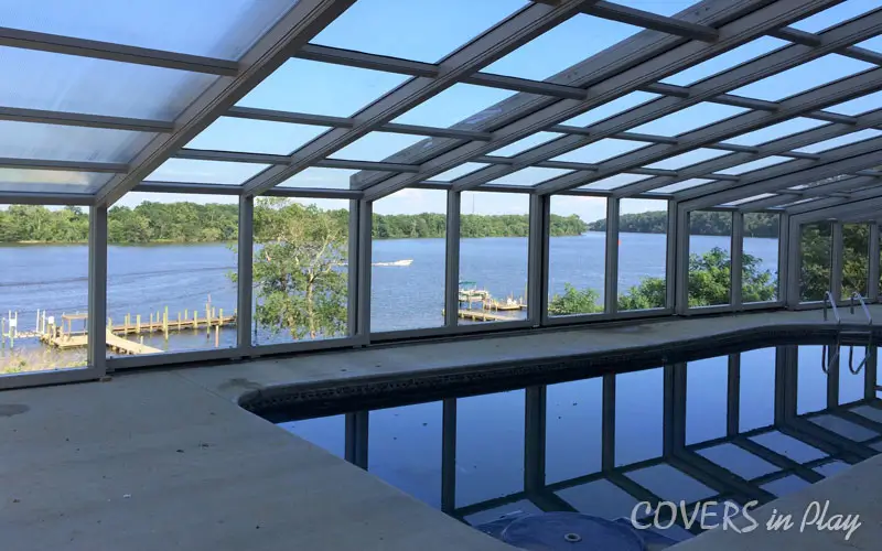 Interior view of residential backyard pool enclosure facing lake in Chester, VA